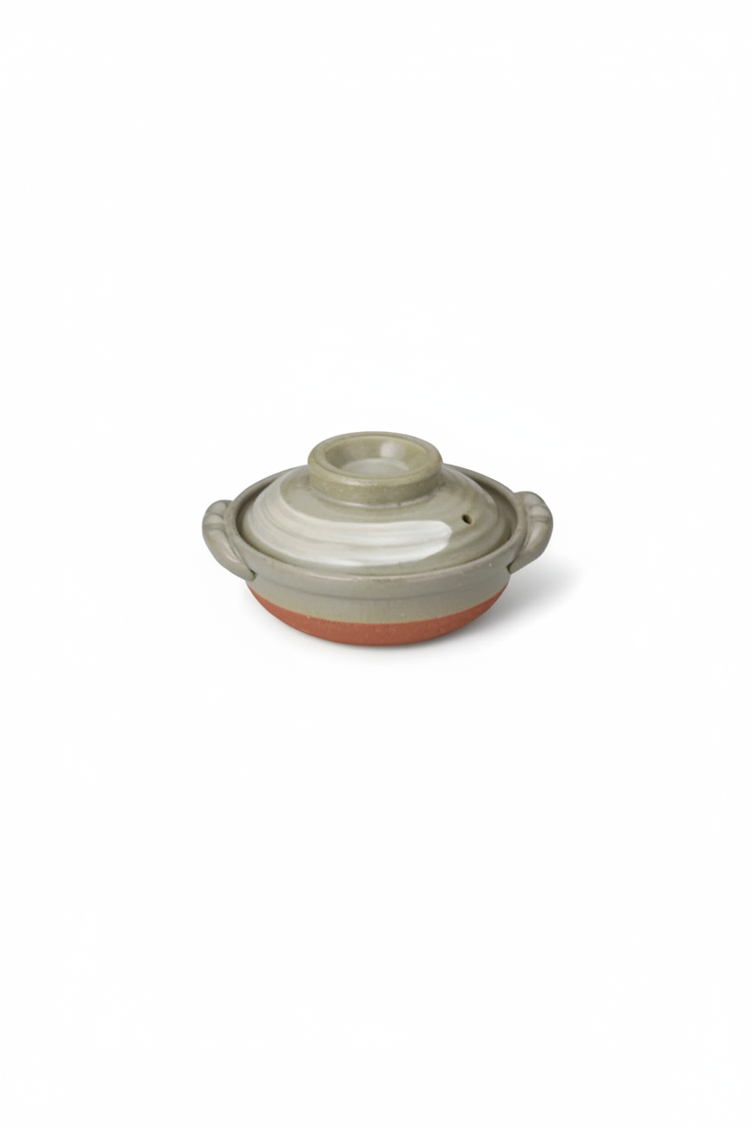 Donabe Kyofu Shirahakeme clay pot on white background, portrait